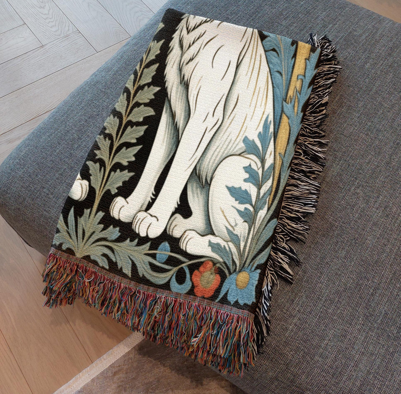 Folded fringed white tiger woven blanket.