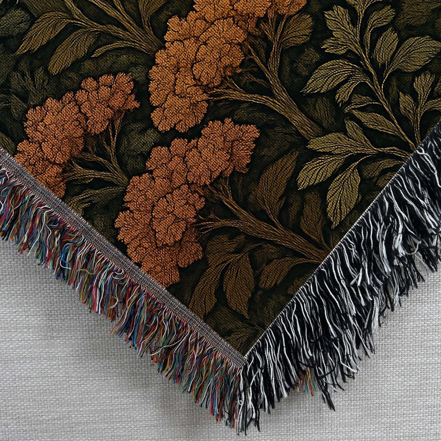 Autumn Forest Woven Blanket with Fringes featuring intricate floral design and colorful fringes.