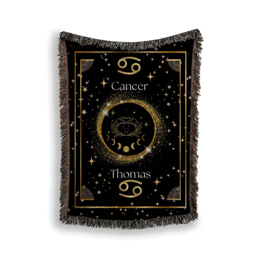 Gold and black Cancer zodiac blanket, made of woven fabric.