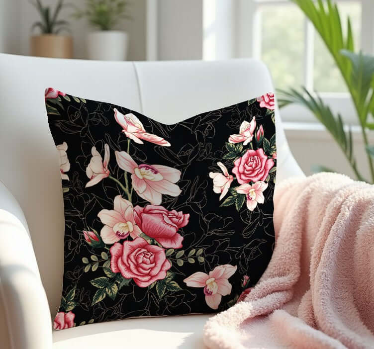Floral Rose Pink and Black Pillow on a white armchair with a pink blanket.