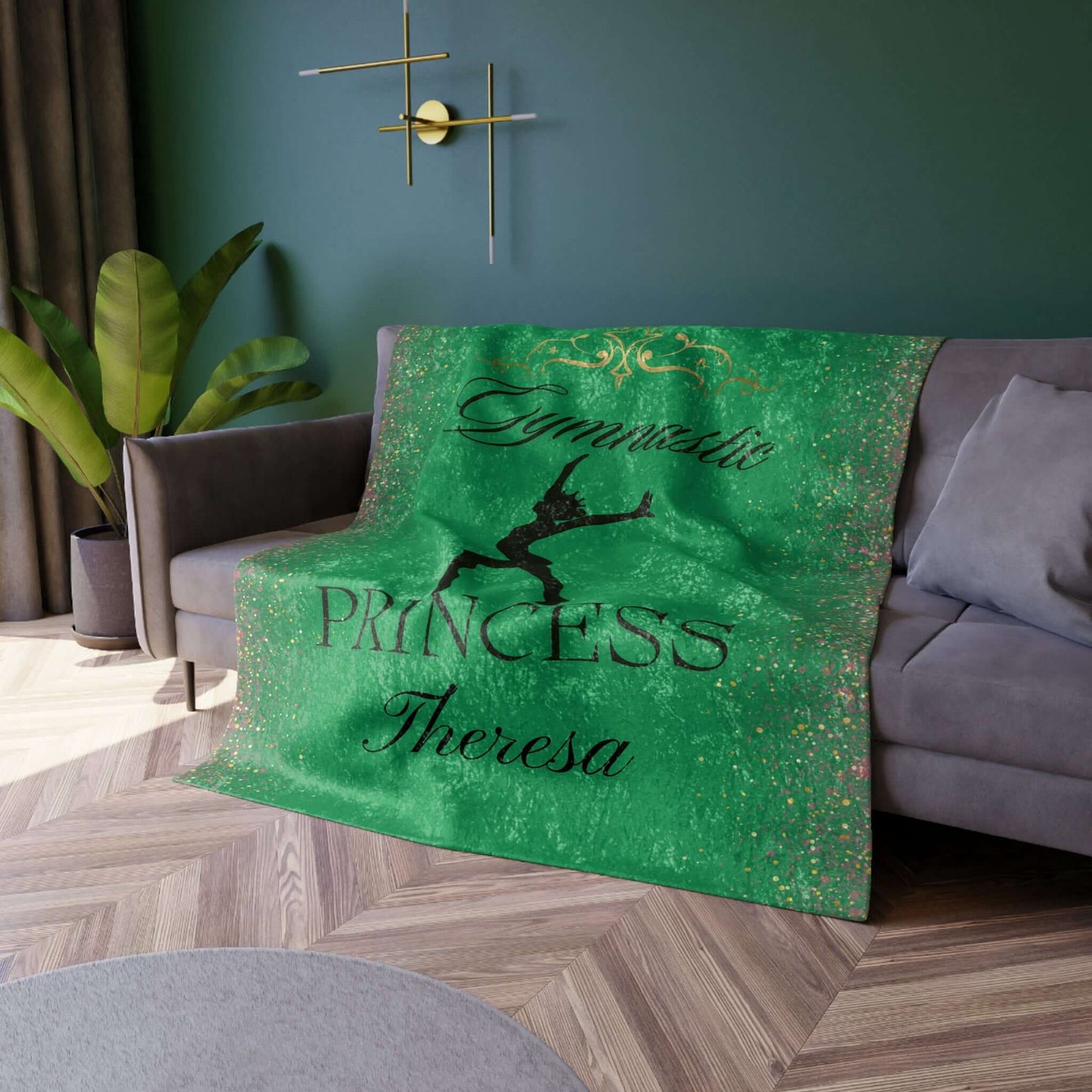 Green Personalized Gymnastics Crushed Velvet Blanket displayed on a couch, featuring gymnast silhouette and personal name.