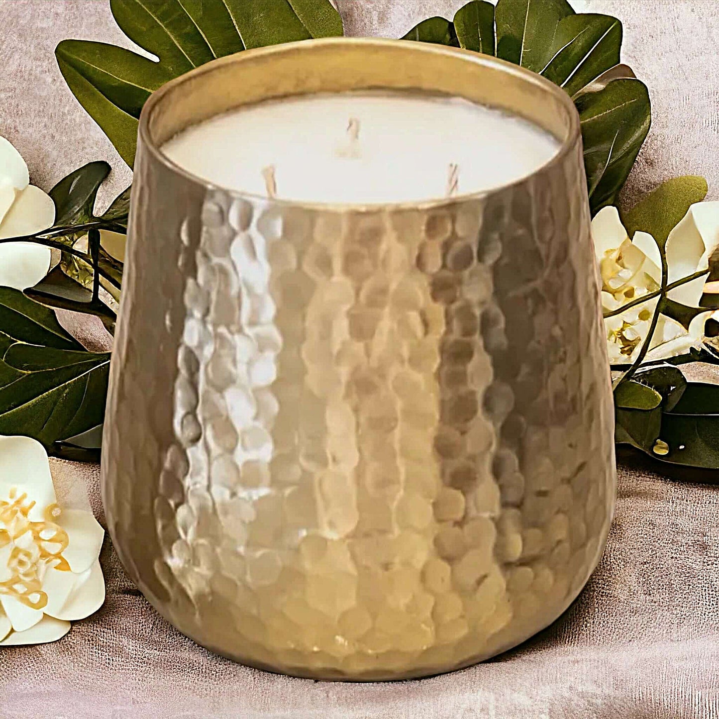 Gold Jumbo Soy Candle in Cranberry Chutney on a table with flowers
