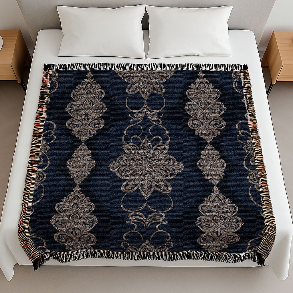 Decorative blanket with intricate patterns on a bed in a bedroom setting