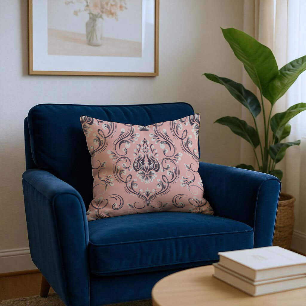 Pink And Navy Damask Woven Pillow on a blue armchair in a bright living room setting.