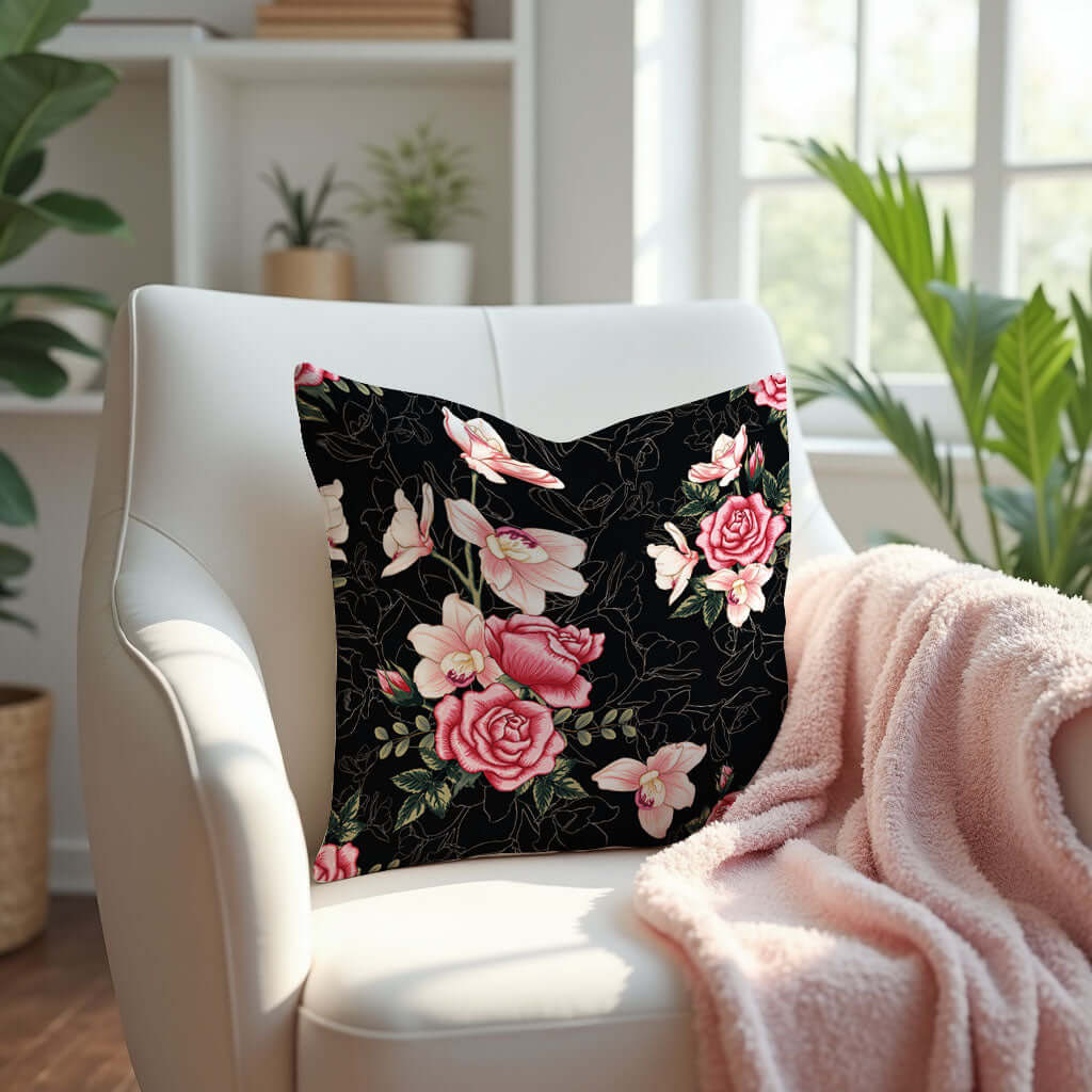 Floral Rose Pink and Black Pillow on a white armchair with a pink blanket.