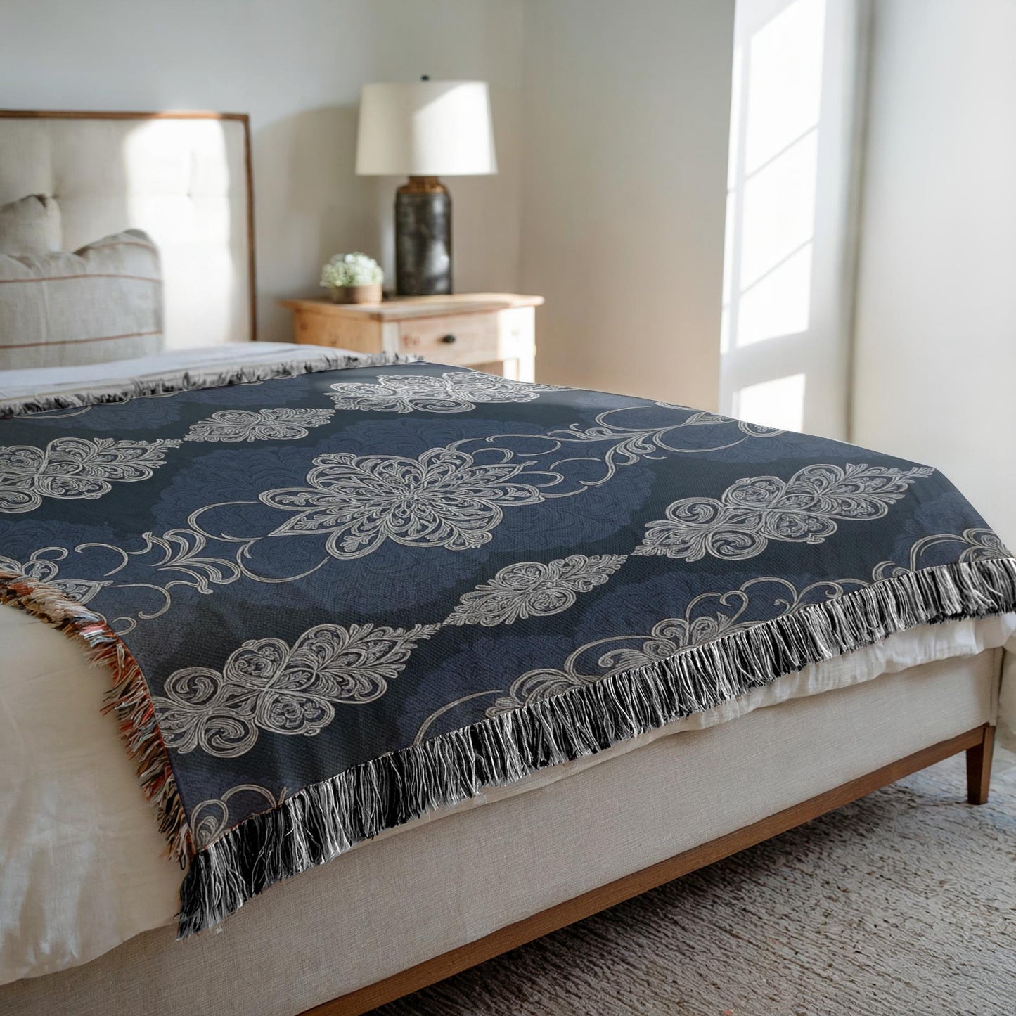 Bedroom with a bed featuring a decorative navy blanket.