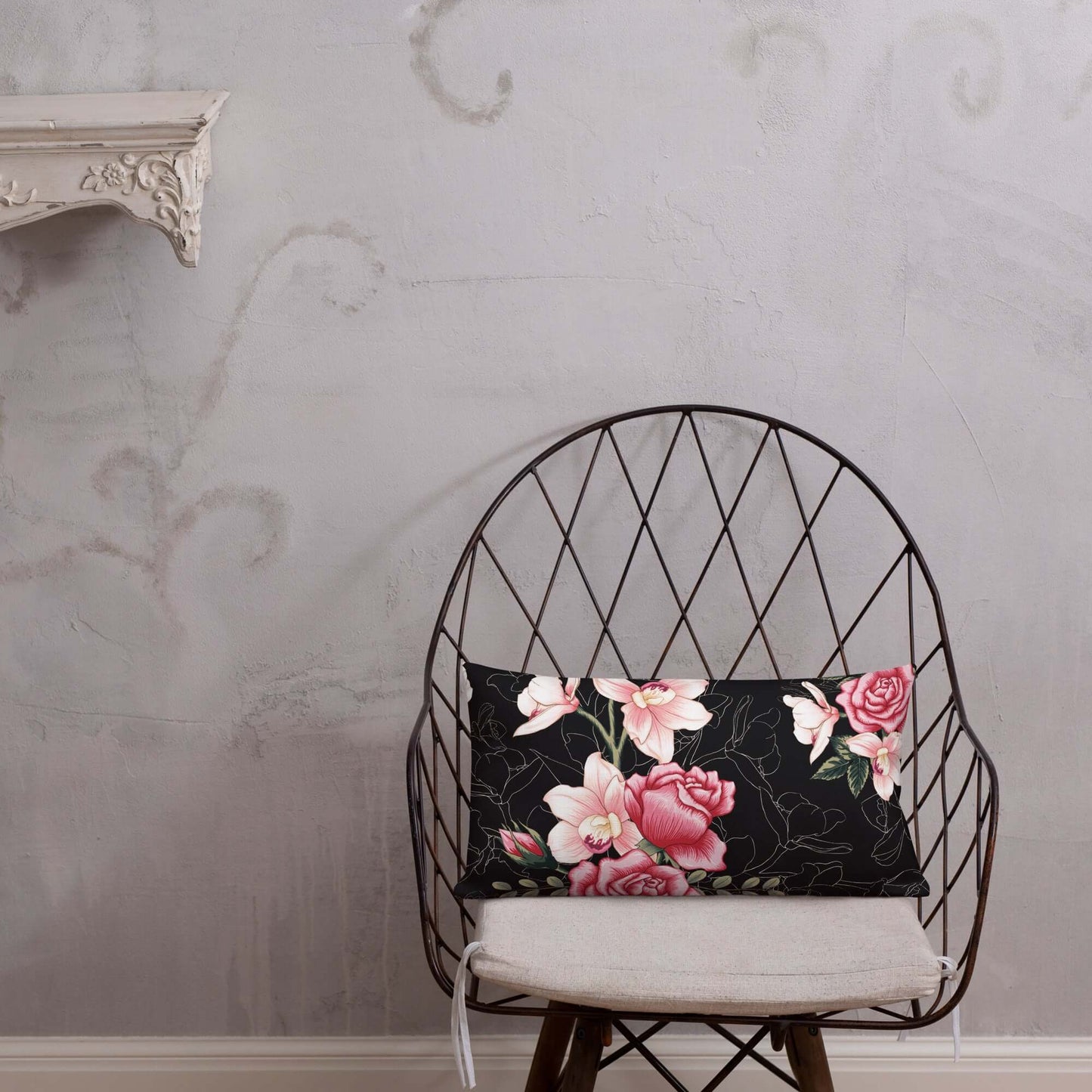 Floral Rose Pink and Black Lumbar Pillow on a wooden chair.