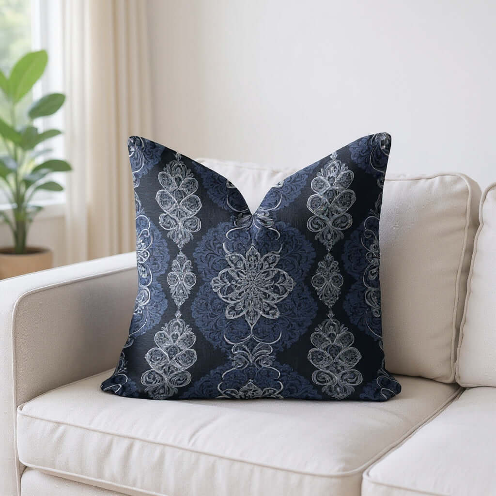 Closeup of the Navy White Damask Woven Pillow on a white sofa