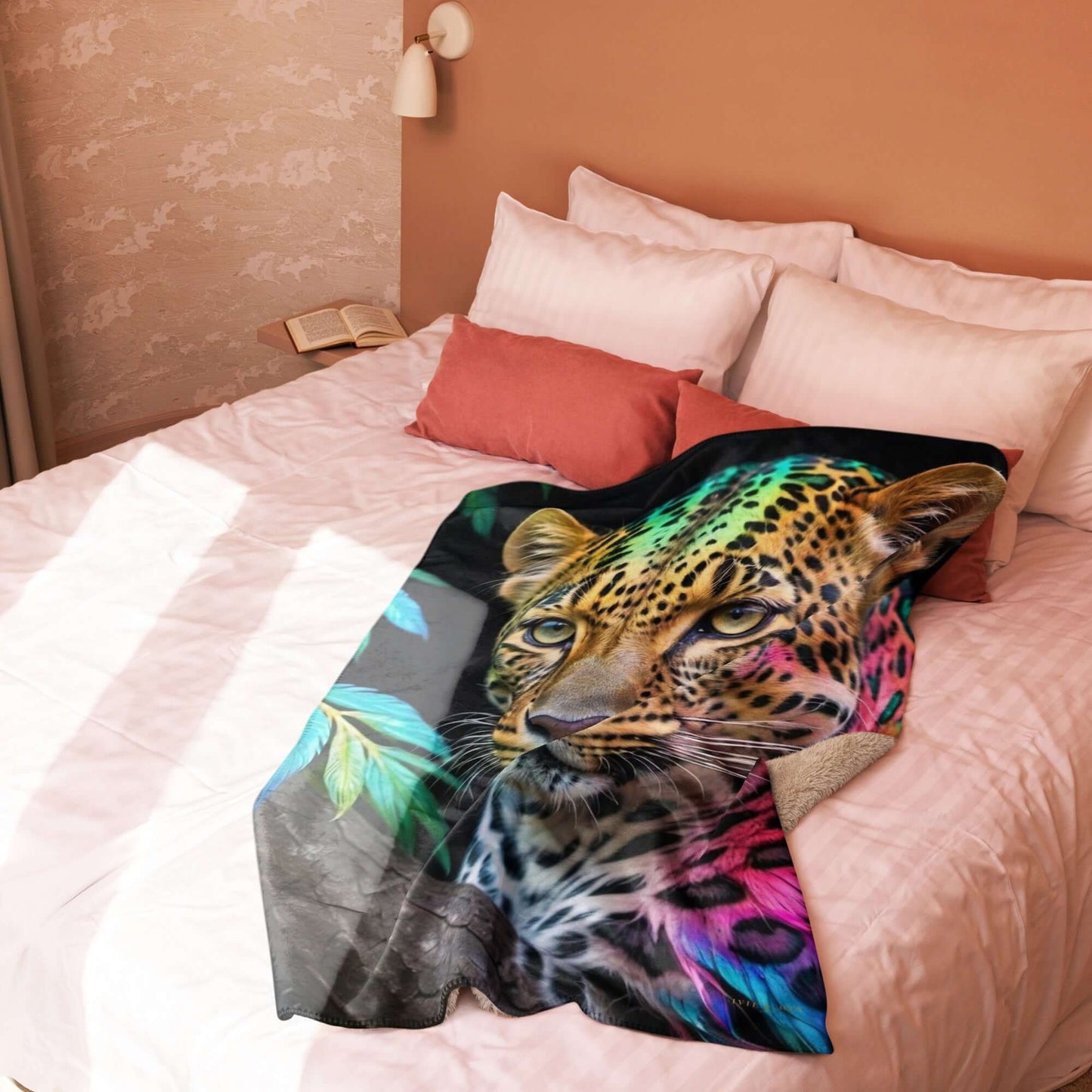 Neon Cheetah Printed Sherpa Blanket draped on a bed with pink linens and pillows