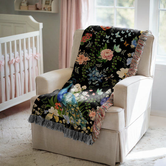 Black Peacock Floral Woven Blanket with Fringes draped over a chair in a cozy living space.