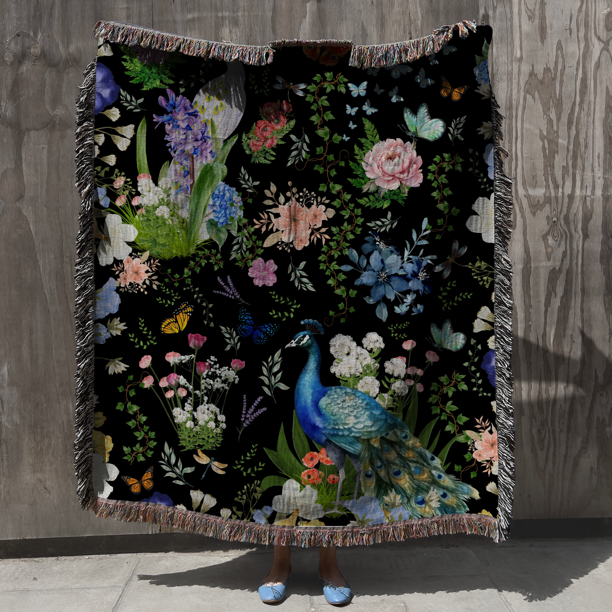 Black Peacock Floral Woven Blanket with Fringes featuring vibrant floral designs and a peacock illustration.