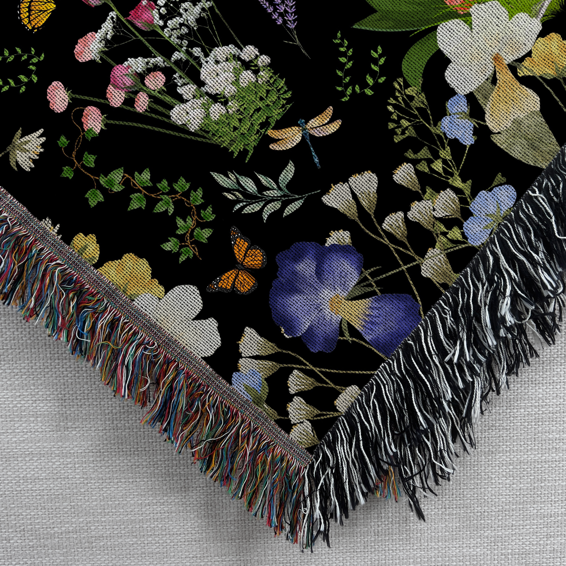 Black Peacock Floral Woven Blanket with Fringes featuring intricate floral designs and colorful details on a black background.