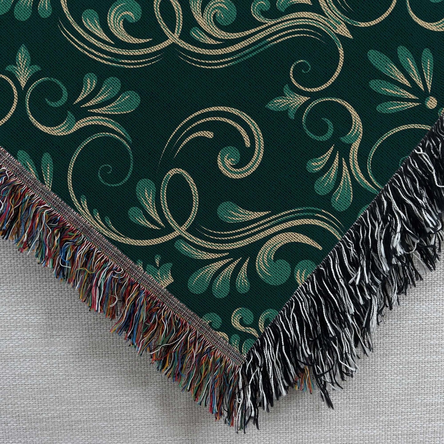 Close up corner view of the Dark Green Damask Woven Blanket 