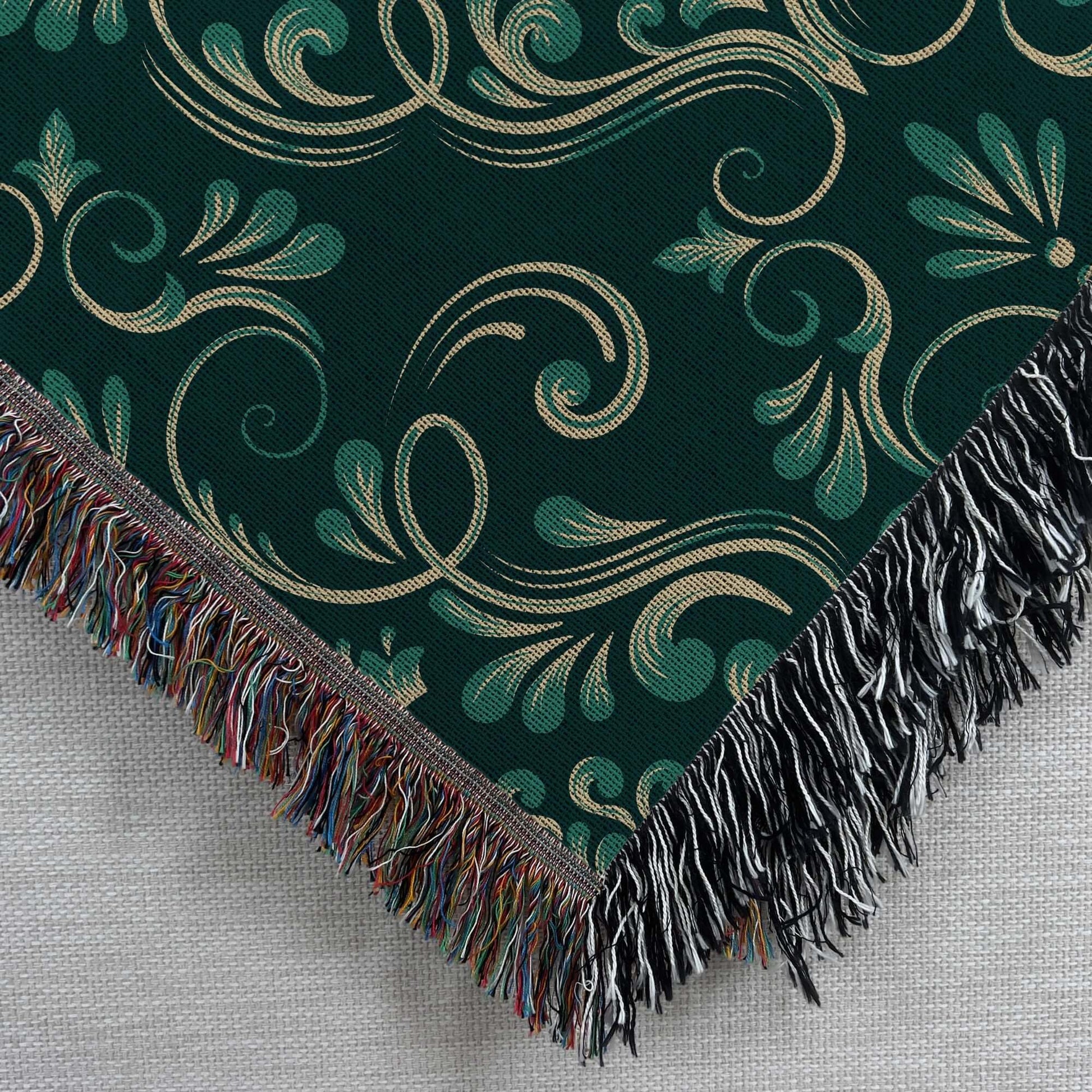 Close up corner view of the Dark Green Damask Woven Blanket 