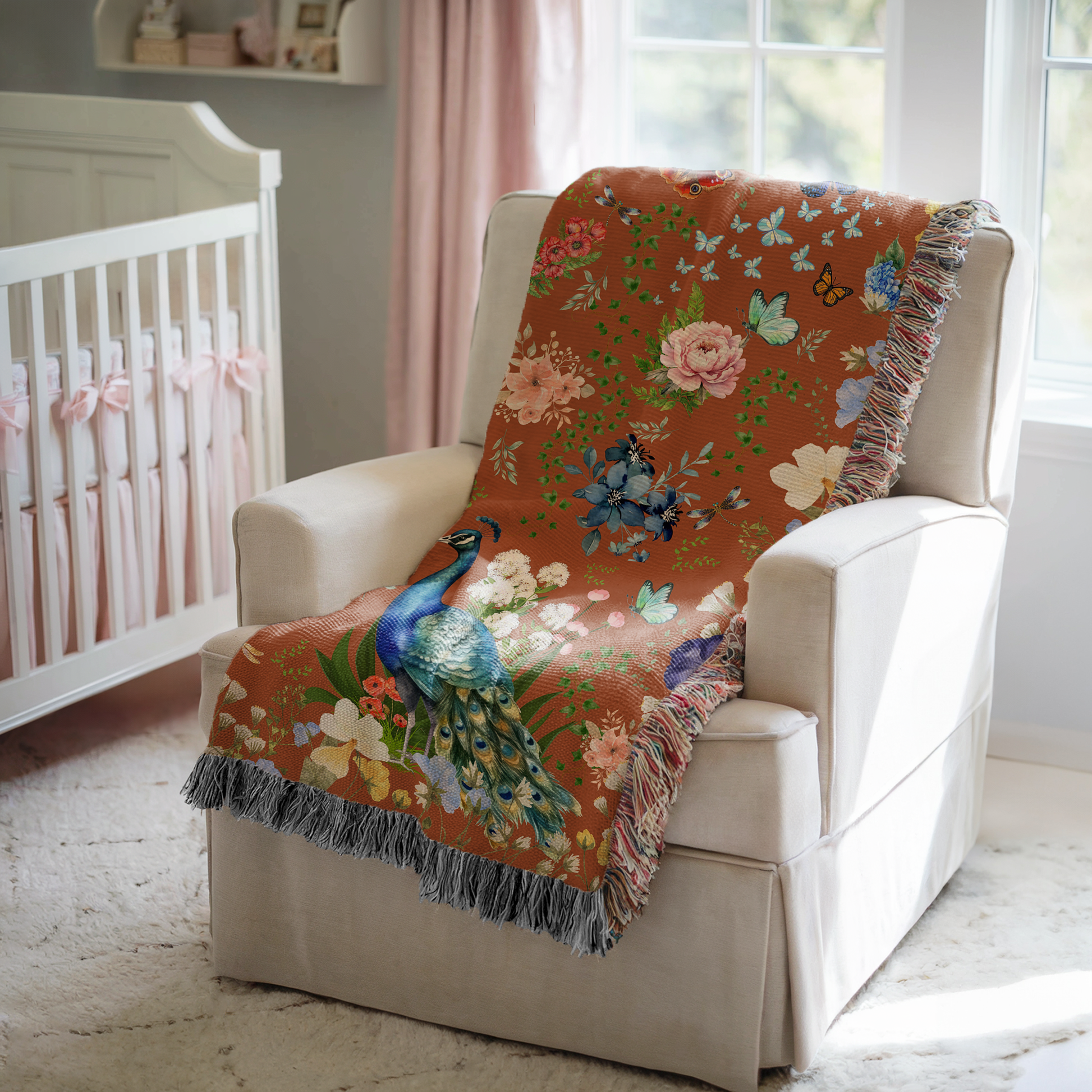 Cinnamon Brown Peacock Floral Woven Blanket draped over a white chair in a baby nursery.