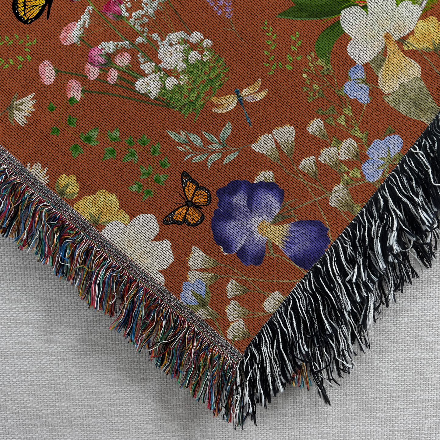 Closeup view of the Cinnamon Brown Peacock Floral Woven Blanket