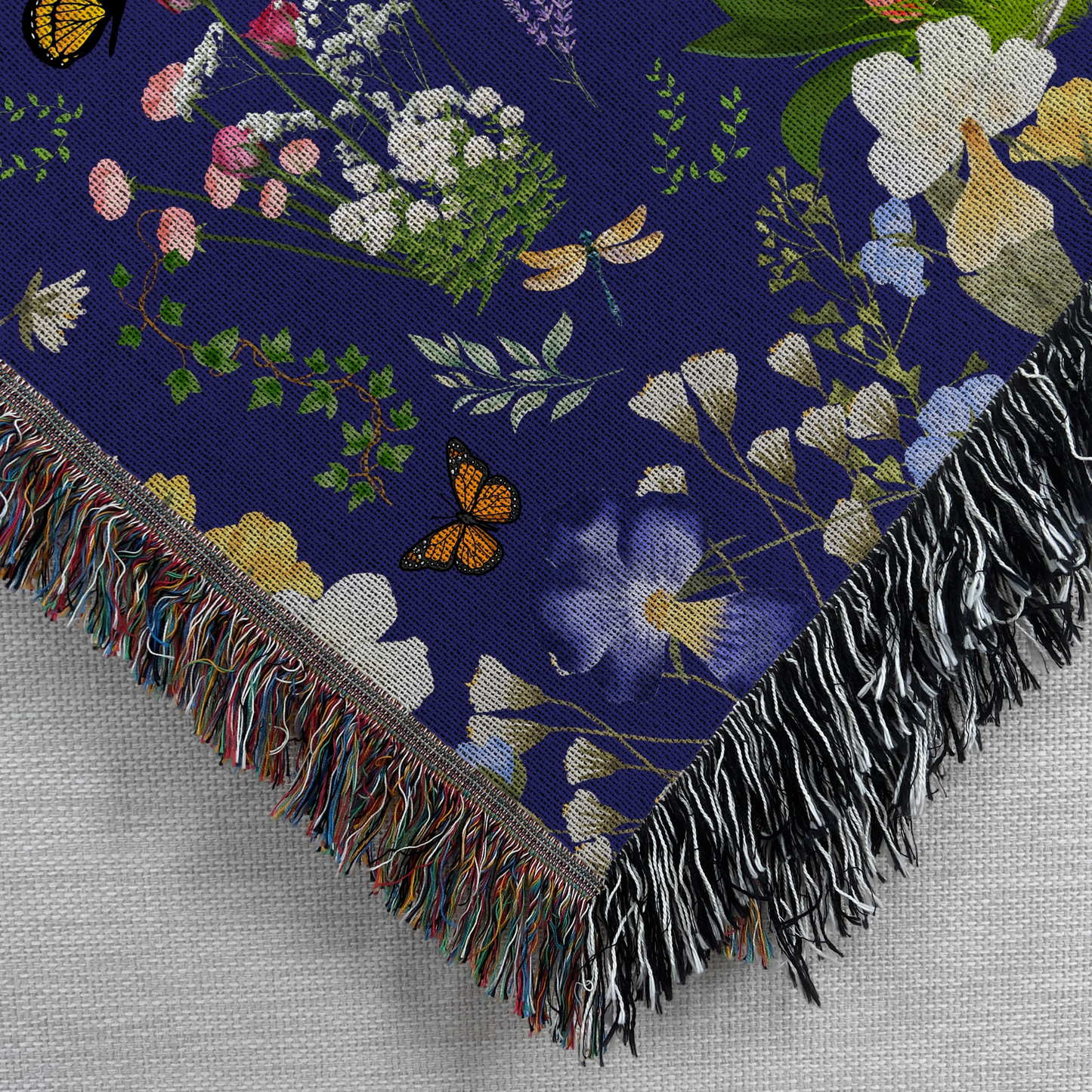 Closeup view of a corner of the Blue Peacock Floral Woven Blanket with Fringes 