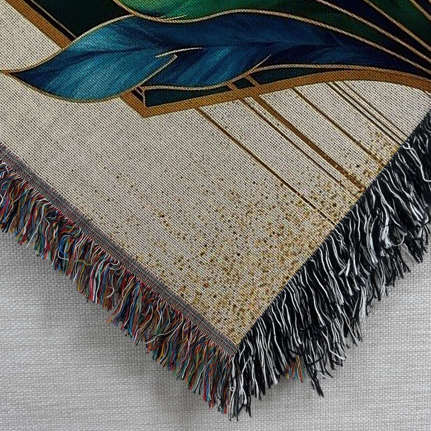 Closeup corner view of the Art Deco Woven Blanket in Blue Green Gold
