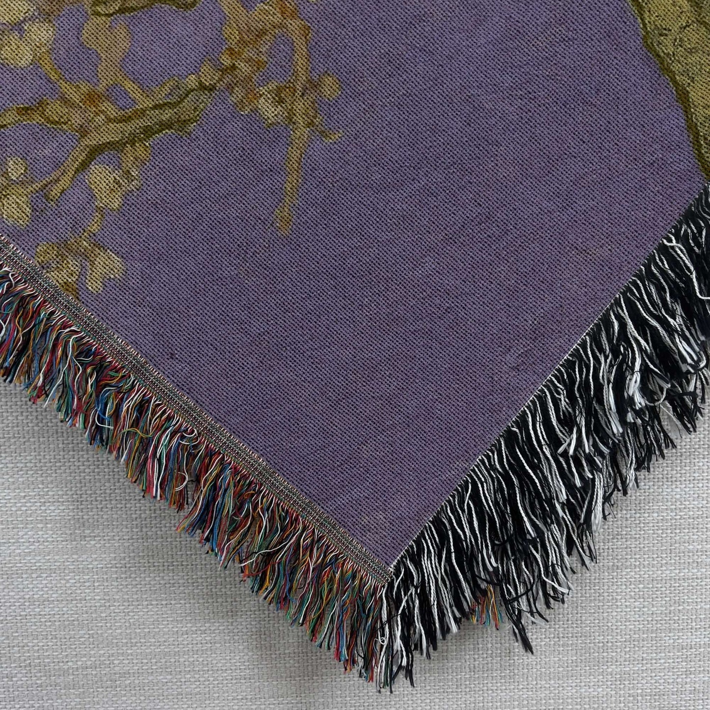 Lavender Almond Blossom Woven Blanket with intricate floral design and colorful fringe detail.