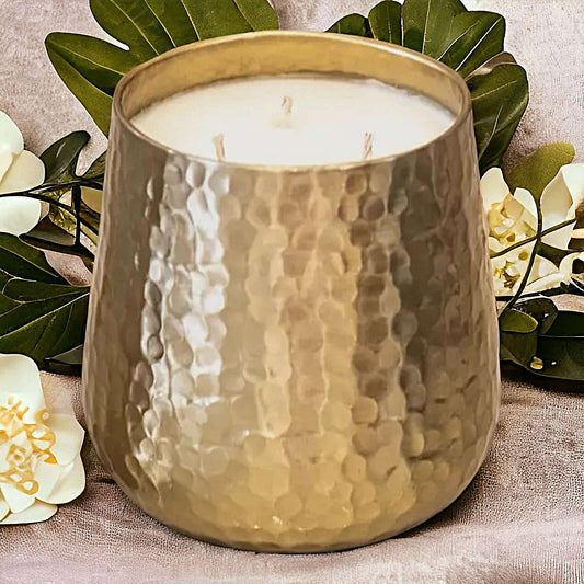 Gold Jumbo Soy Candle in Cranberry Chutney on a table with flowers