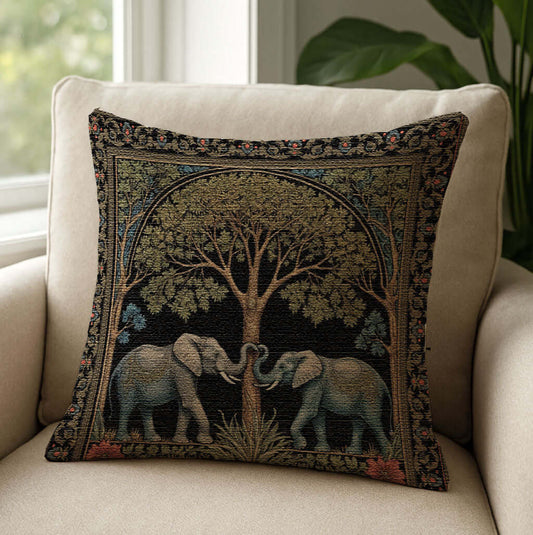 Elephant Love Woven Pillow Tapestry resting on a beige armchair, next to a window 