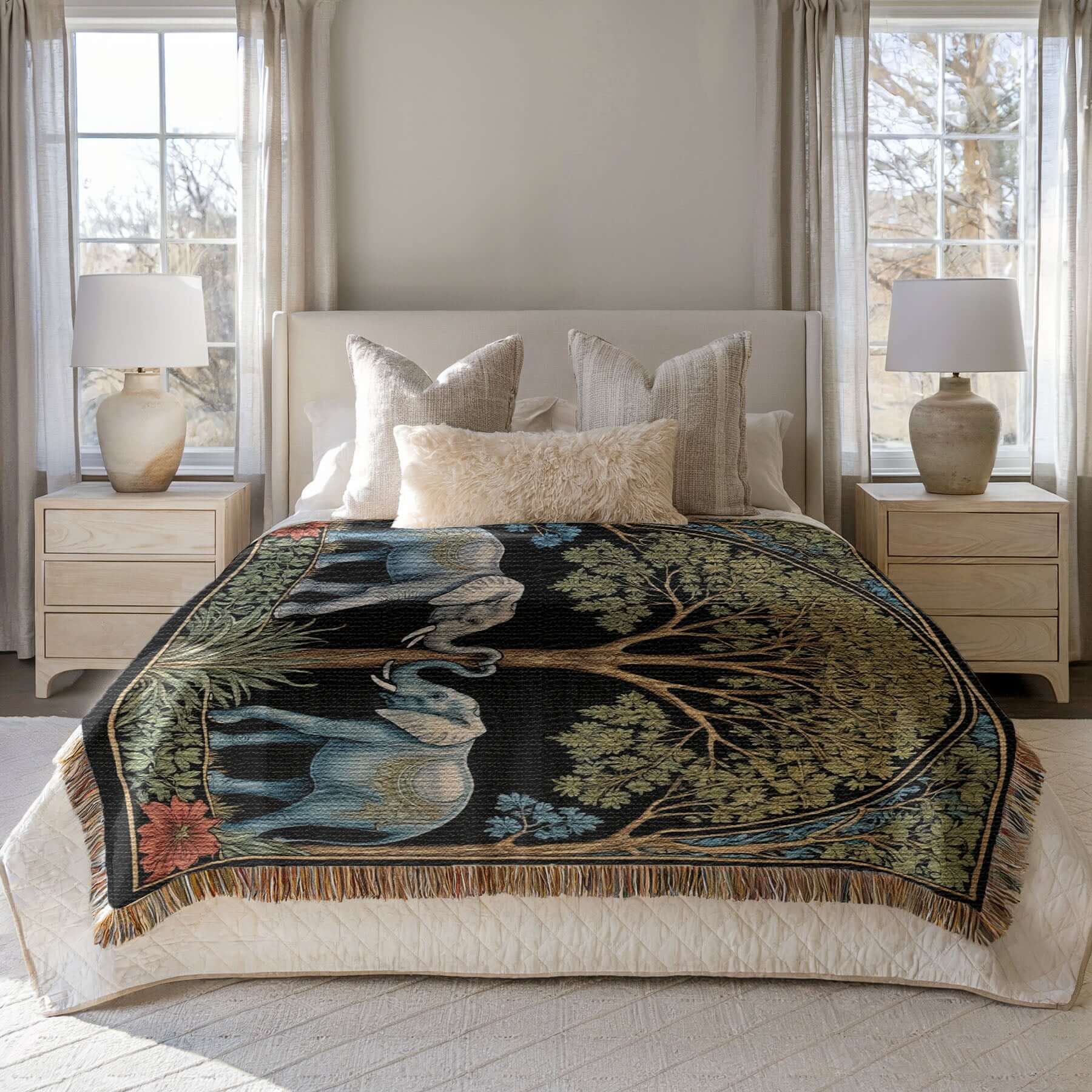 Two elephants on a woven fringed blanket spread out on a bed.