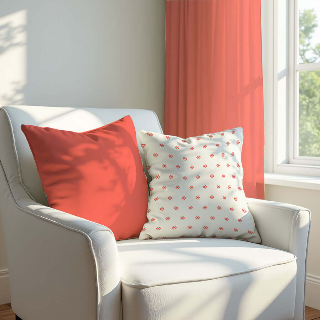 Coral and Floral Pillows on a white armchair.