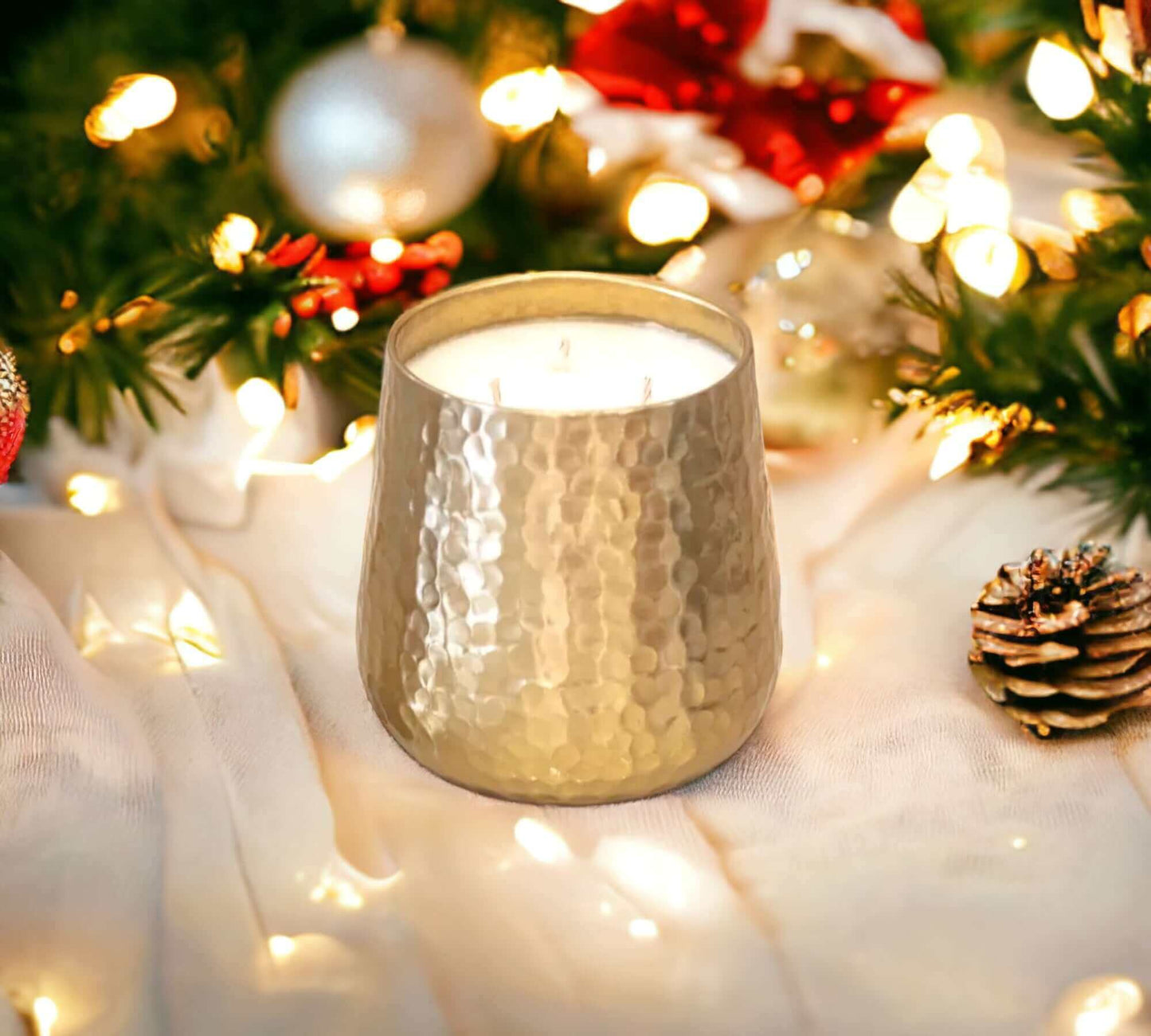 Gold Jumbo Soy Candle in Peppermint Mocha on a white marble table with a Christmas tree in the background