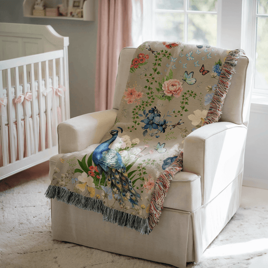 Gray Peacock Floral Woven Blanket with Fringes draped over a white chair in a nursery.