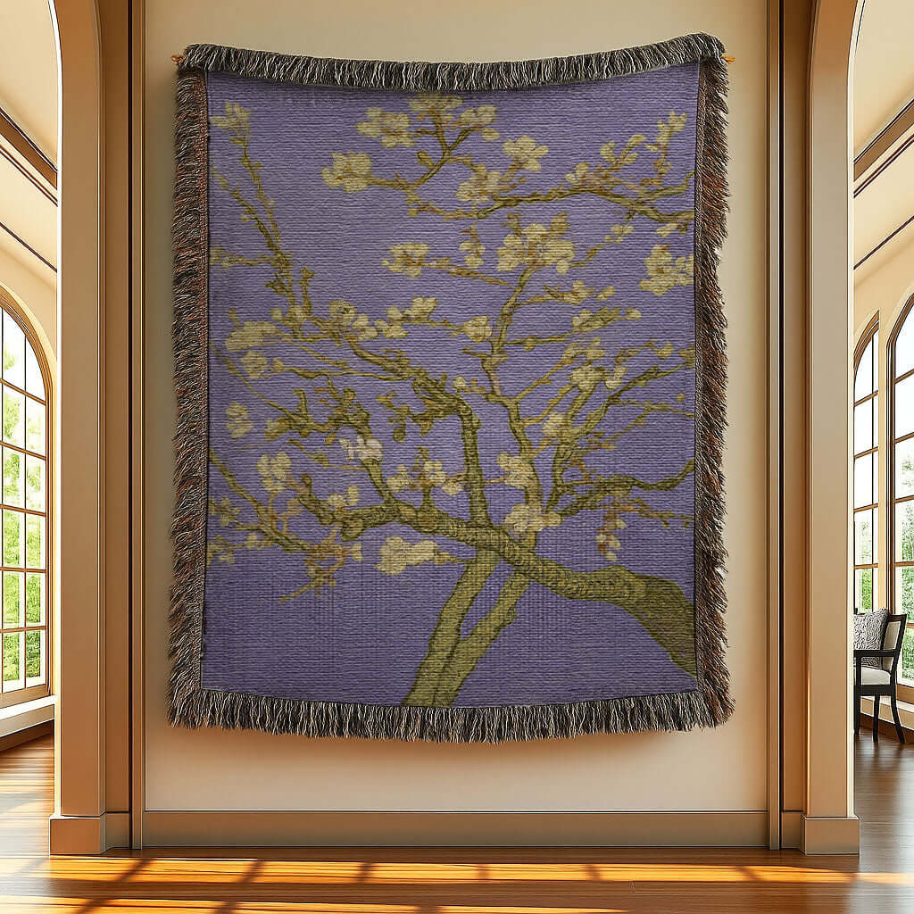 Lavender Almond Blossom Woven Blanket hanging on a wall, featuring delicate blossoms against a lavender background.