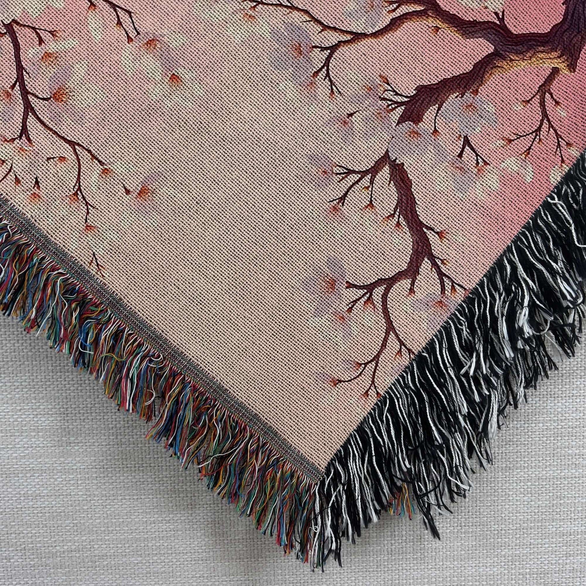 Closeup corner view of the Pink Almond Blossom Woven Blanket.