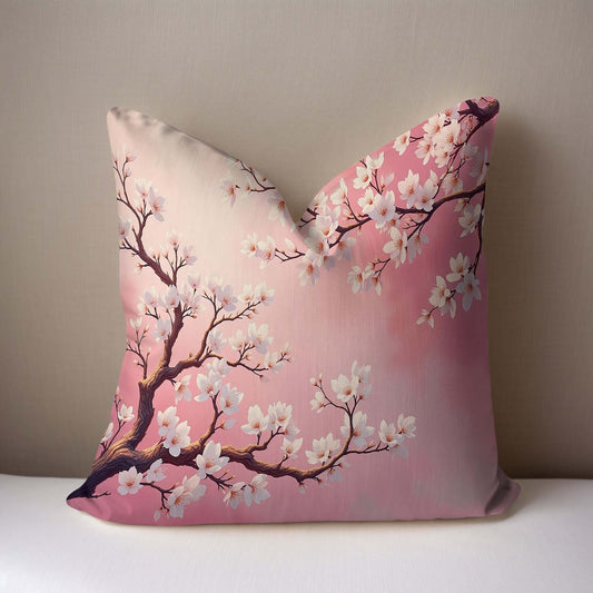Pink Almond Blossom Woven Pillow on a white surface with a taupe background.
