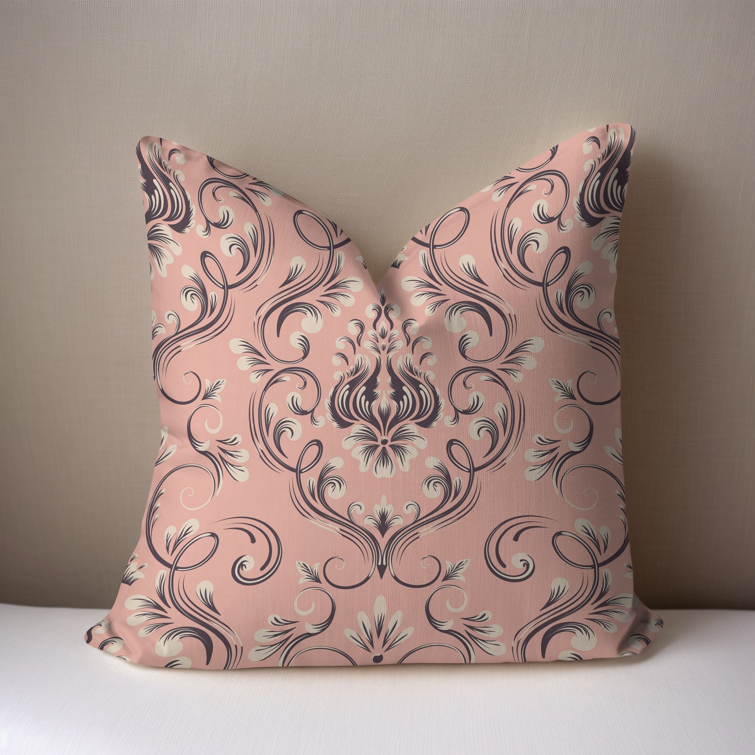 Decorative pillow with pink and black floral pattern on a beige background