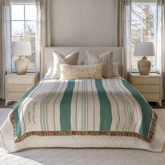 Personalized Striped Woven Blanket draped on a bed.