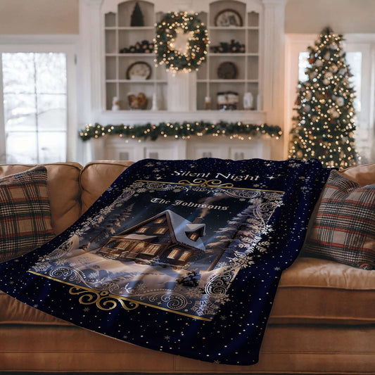 Personalized Silent Night Christmas Blanket draped over a brown sofa with Christmas decorations in the background