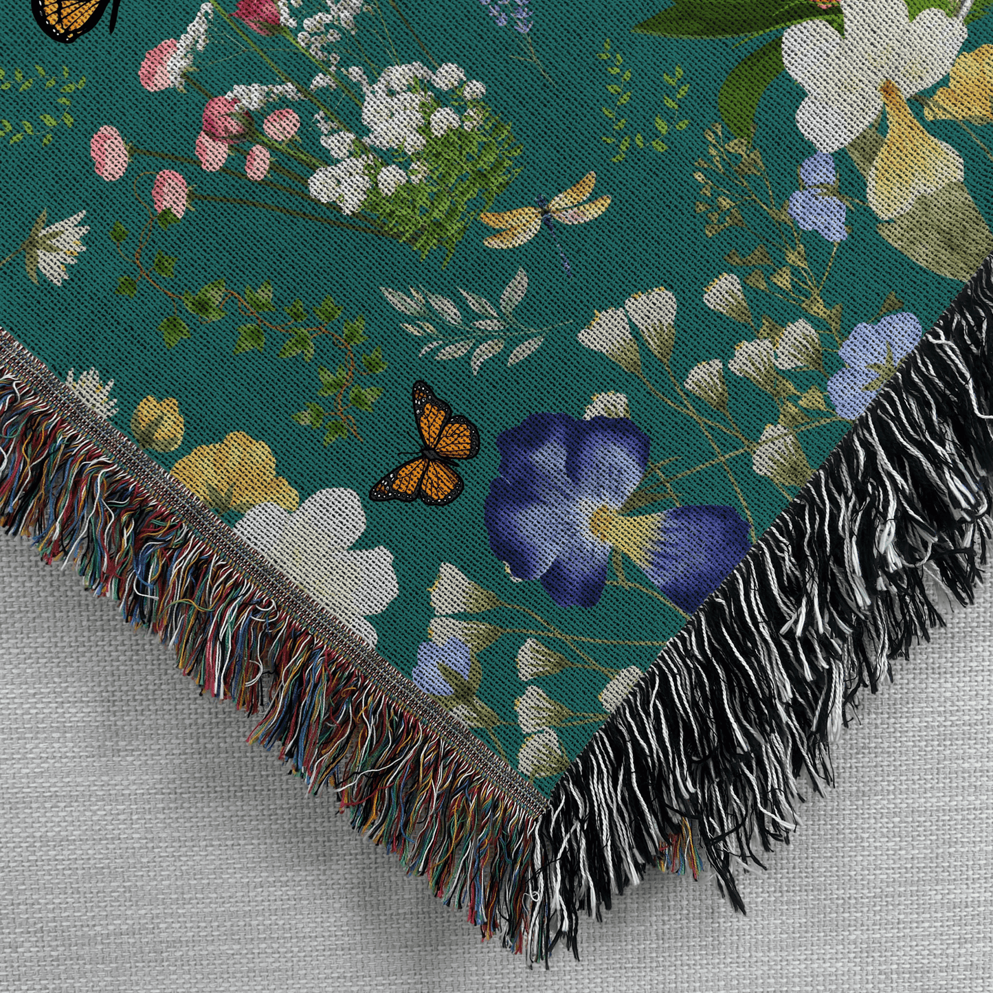 Closeup corner view of the Teal Peacock Floral Woven Blanket with Fringes