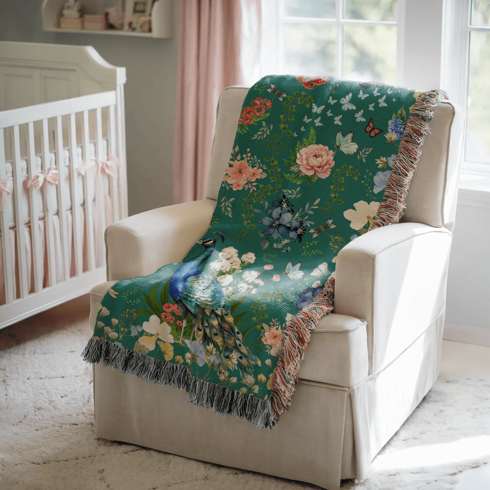 Teal Peacock Floral Woven Blanket with Fringes draped over a white chair in a baby nursery.
