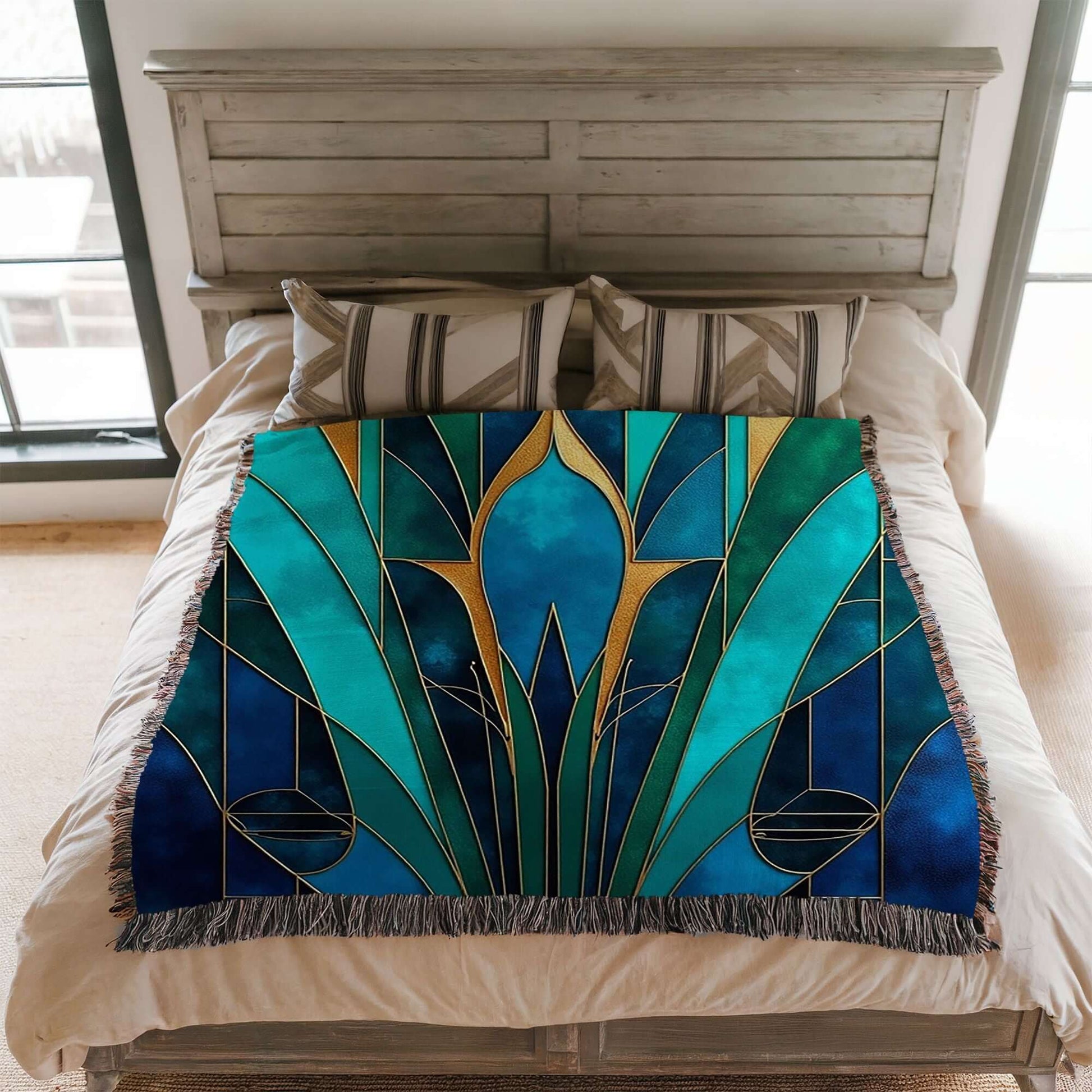 Blanket that matches the Blue And Teal Art Deco Woven Pillow on a bed