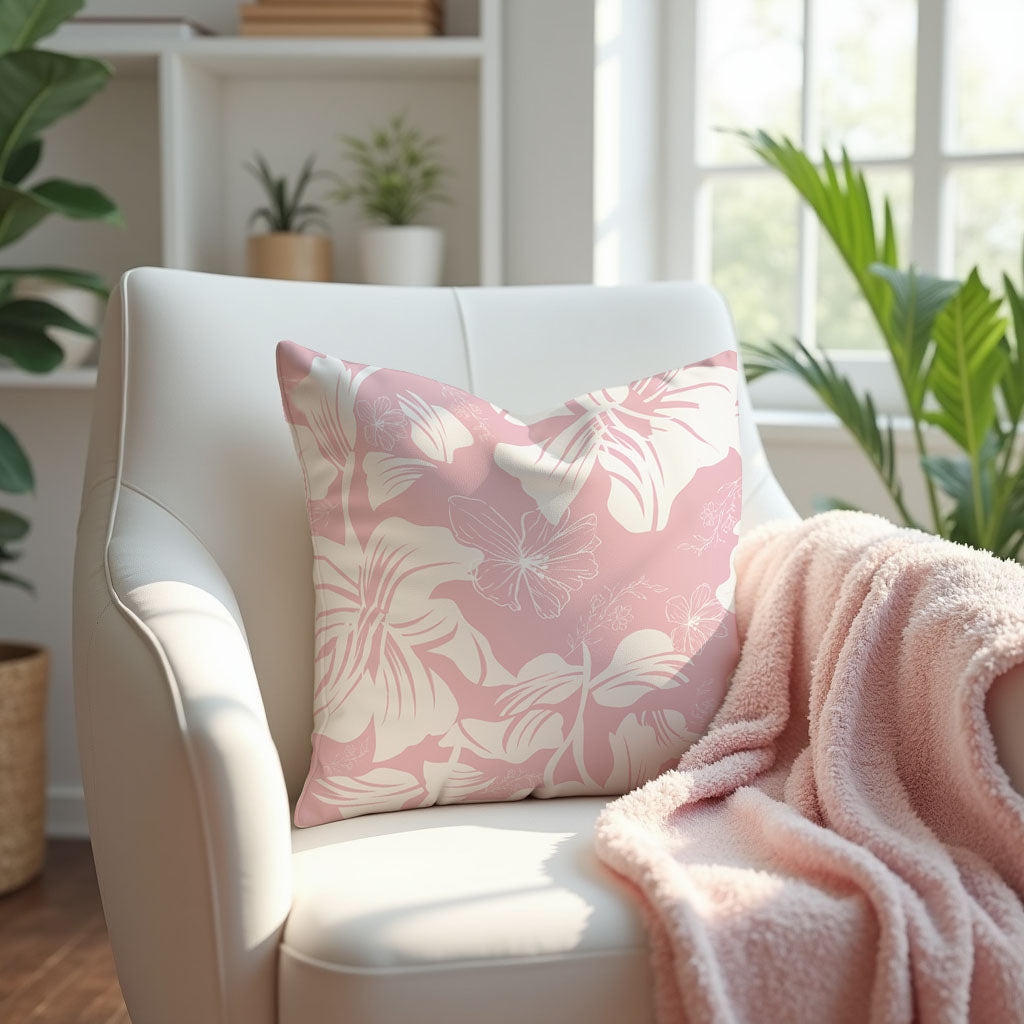 Pink and White Floral Pillow Cover on a white armchair with a pink blanket.