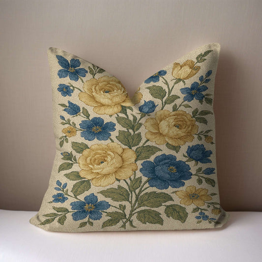 Yellow and blue floral Cottagecore pillow on a white surface with a taupe background