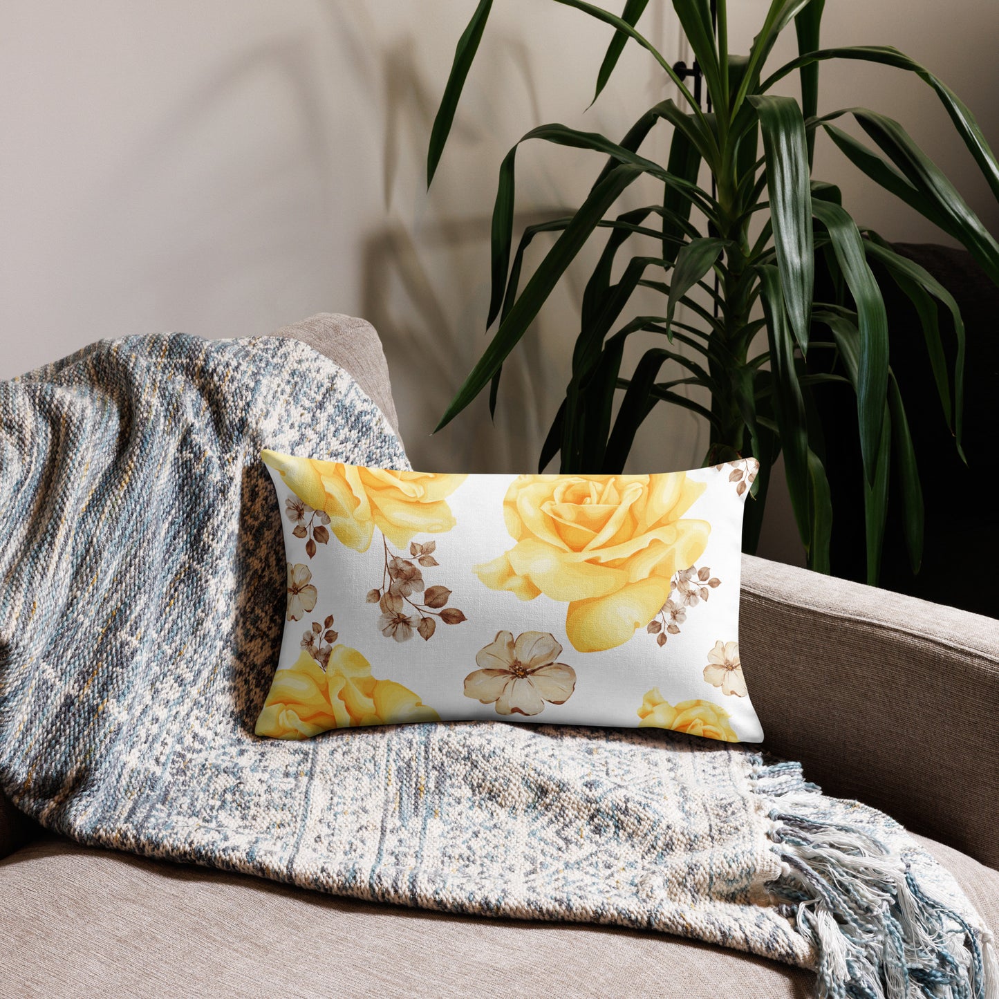Yellow and white floral pillow on a sofa.