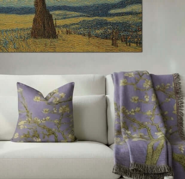 Van Gogh Almond Blossom Woven Pillow in Lavender with a matching blanket on a white sofa in a well lit modern livingroom