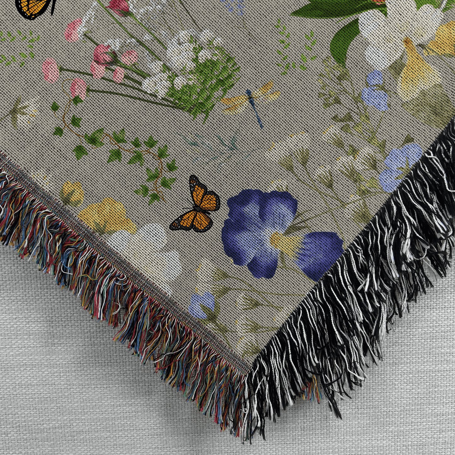Closeup corner view of the Gray Peacock Floral Woven Blanket with Fringes