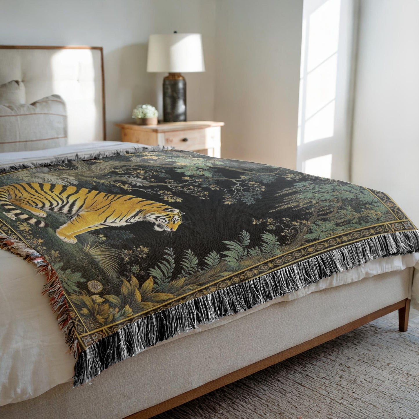 Side view of the Exotic Tiger Woven Throw Blanket draped over a bed bathed in sunlight